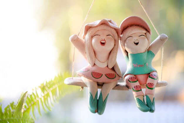 Close-up of figurine toy on swing