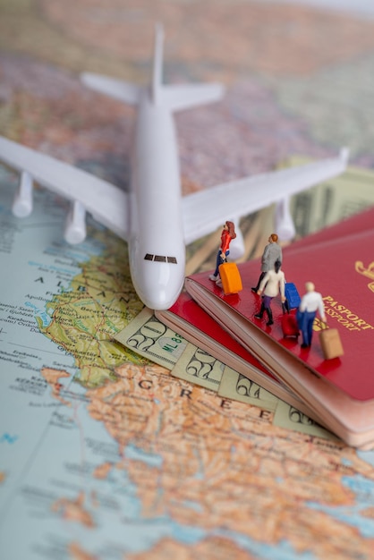 Photo close-up of figurines boarding airplane model on map and passports