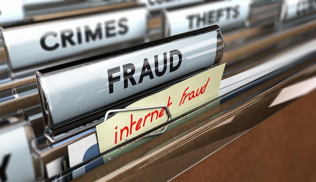 Close up on a file tab with the text fraud plus a note where it is handwritten internet frauds. Blur effect. Concept image for illustration of online scams or cybercrime.