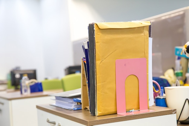 Close-up files folder stack on office desk.