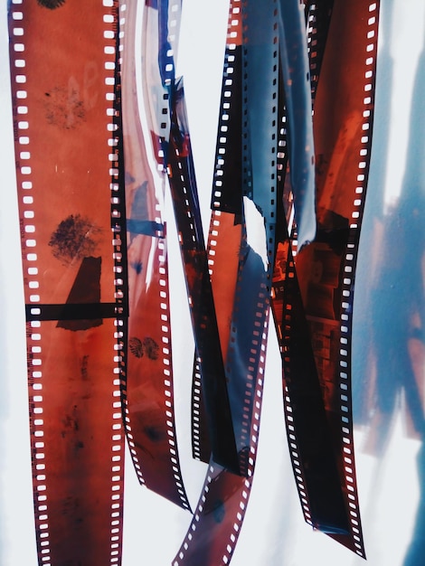 Photo close-up of film reels hanging against white background