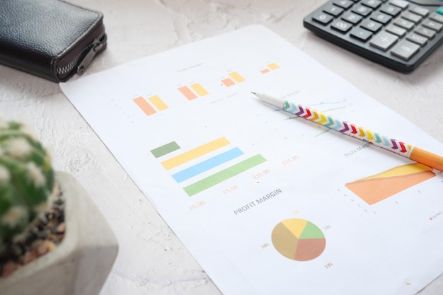 Close up of financial charts and pen on table