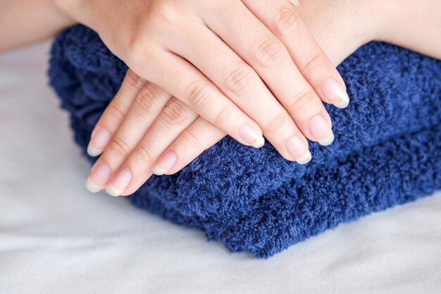 Close-Up fingernail of women on blue towel, Concept of health care of the fingernail.