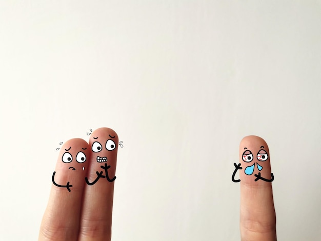 Photo close-up of fingers with smiley against white background