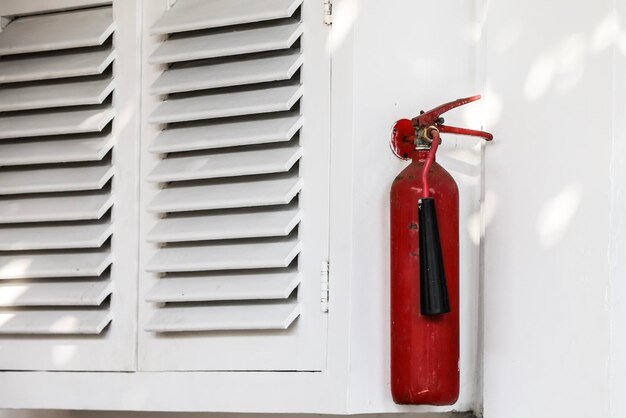 Close-up of fire extinguisher on window