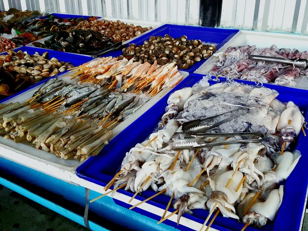 Photo close-up of fishes for sale in market