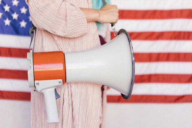 Photo close-up of the flag holding an umbrella against a white wall