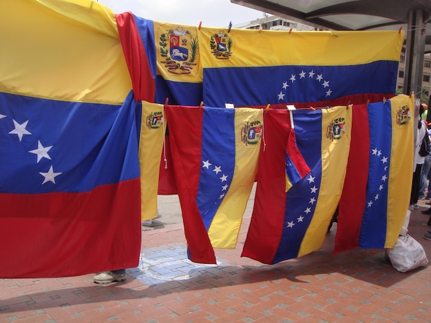 Close-up of flags hanging outdoor small kiosk with veneuelan flags