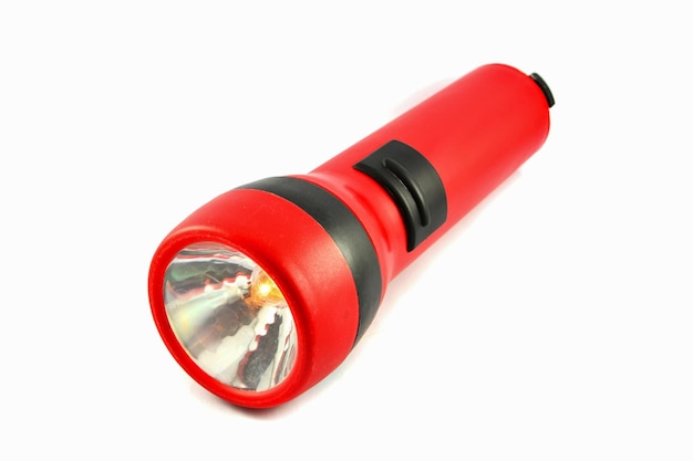 Photo close-up of flashlight against white background