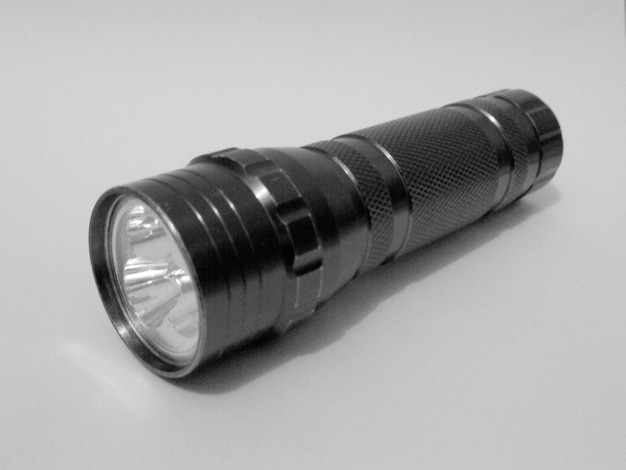 Close-up of flashlight on white background