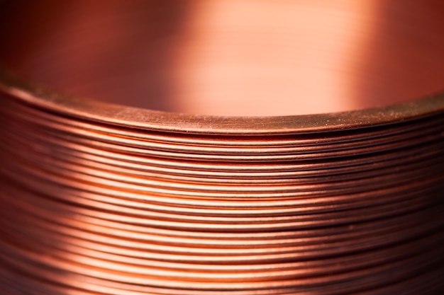 Close-up flat twisted copper wire at a factory for manufacture of components for electronic household appliances and office equipment. Concept manufacturing industrial electronics. Advertising space