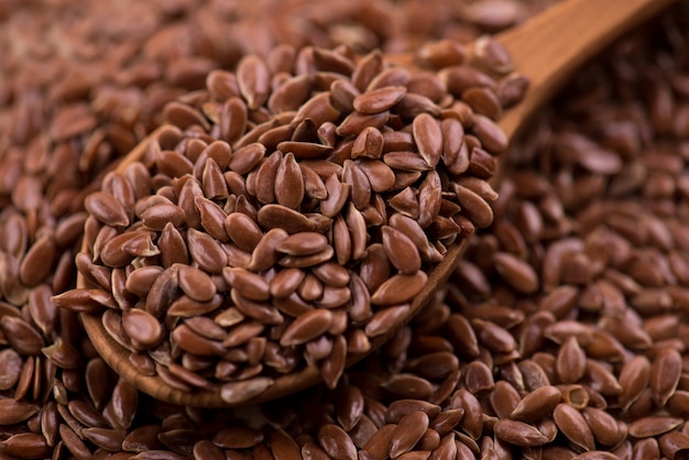 Close up Flax seeds in a wooden spoon.