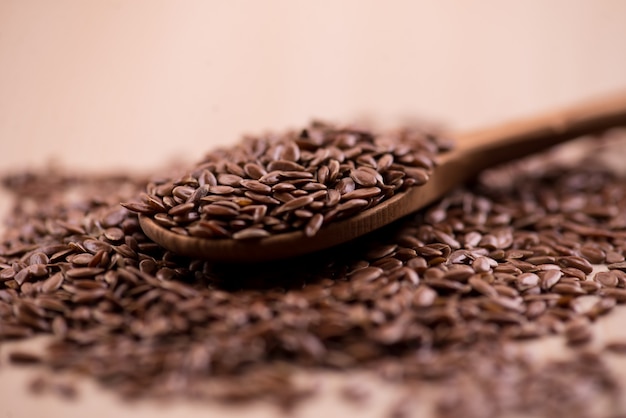 Close up Flax seeds in a wooden spoon.