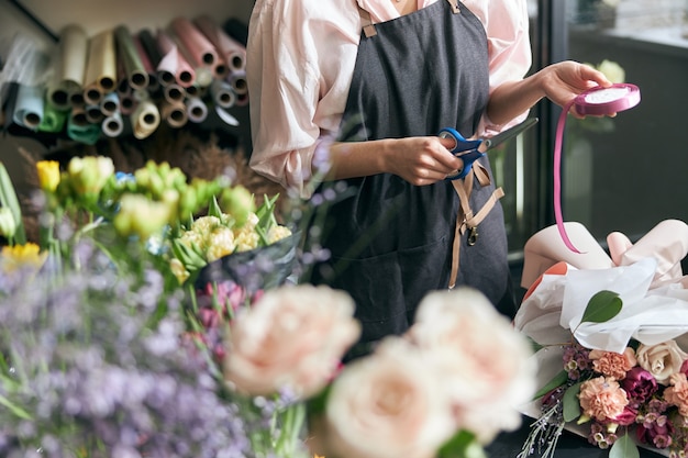 Close up on florist at work working on floral decorations