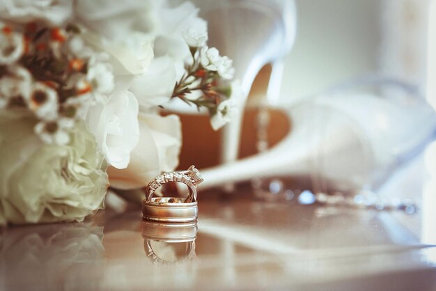 Close-up of flowers and ring on table