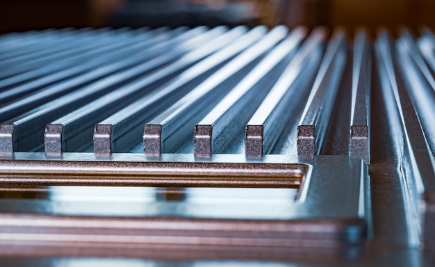 Close-up of a fluted metal surface next to a control panel on an unidentified automatic control device in a factory. The concept of secret military production