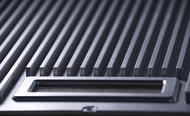 Close-up of a fluted metal surface next to a control panel on an unidentified automatic control device in a factory. The concept of secret military production