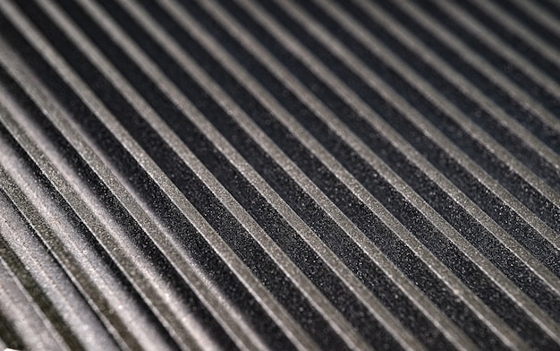 Close-up of a fluted metal surface on an unidentified automatic control device at an automobile factory. The concept of secret engineering. Place for text