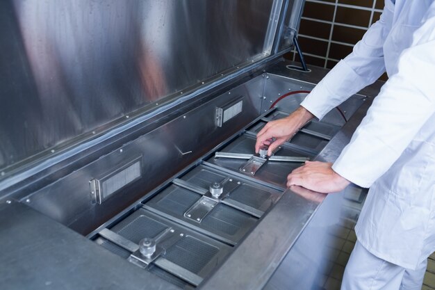 Close up of a focused brewer working at machine