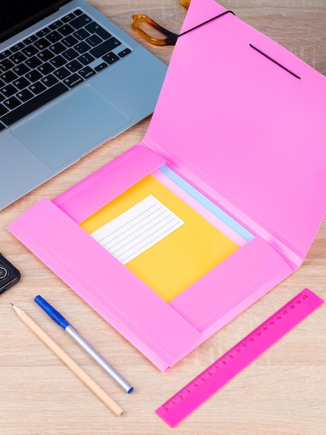 Close up of the folder a notebook on a wooden table are ready for the lesson StationeryBack to school