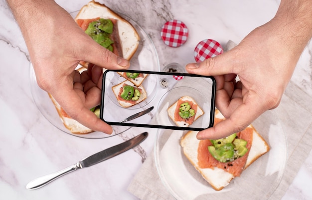 Photo close up on food lover taking pictures of meal