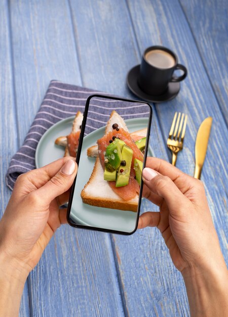 Photo close up on food lover taking pictures of meal