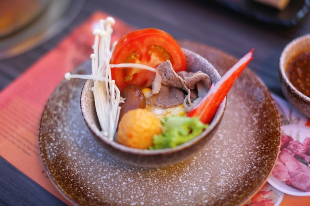 Photo close-up of food served in container on table