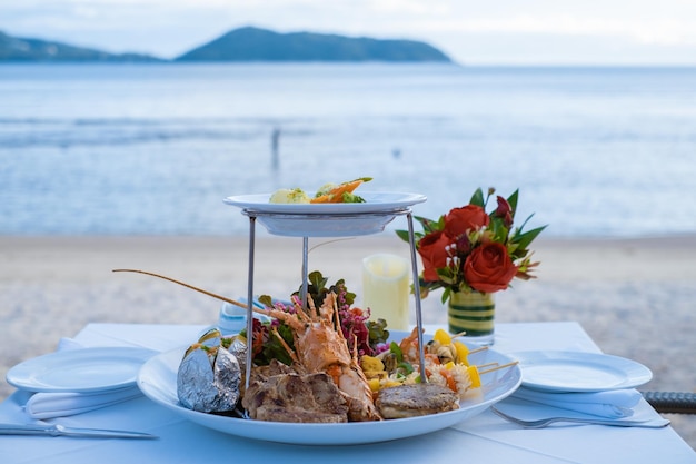 Photo close-up of food on table by sea