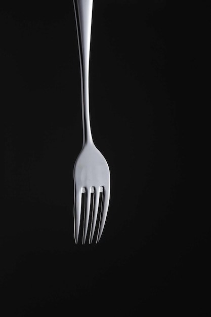 close-up of fork against black background