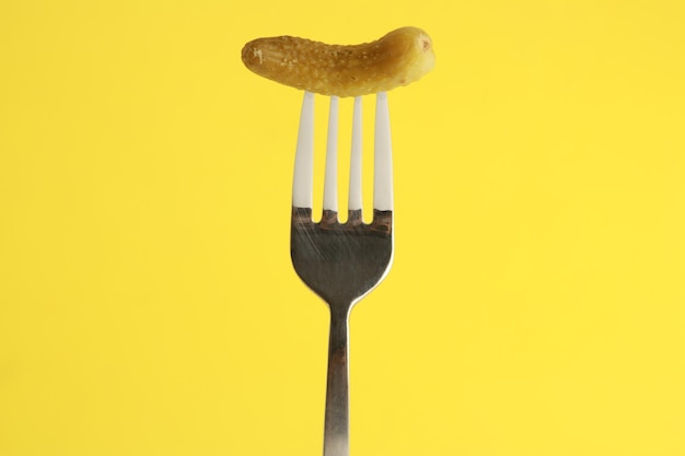 close-up of fork against yellow background