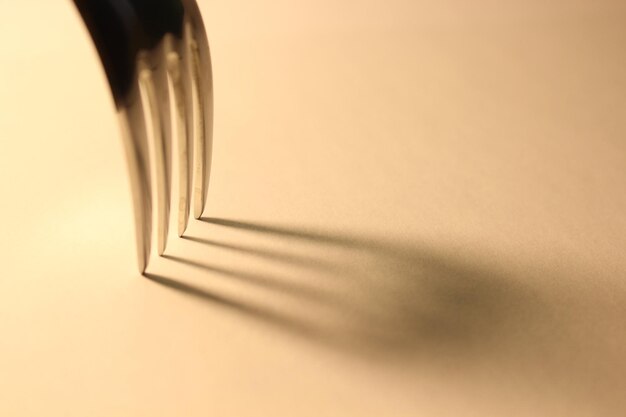 Photo close-up of fork on white table