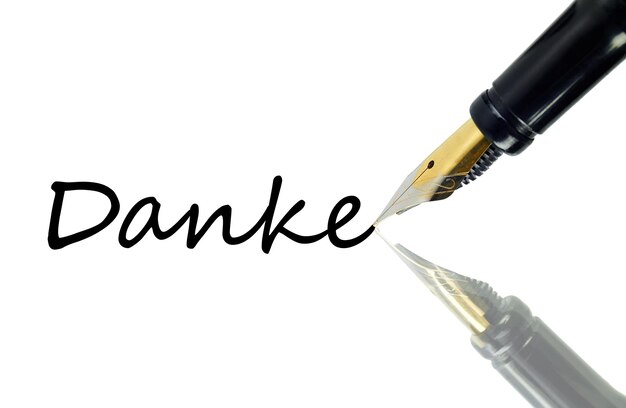 Photo close-up of fountain pen with text on white background