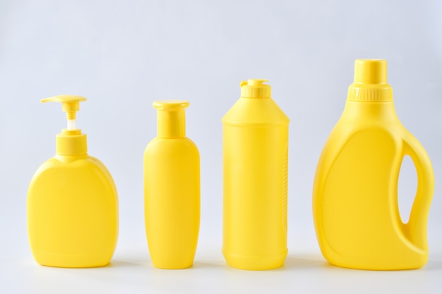 Close-up of four yellow plastic bottles