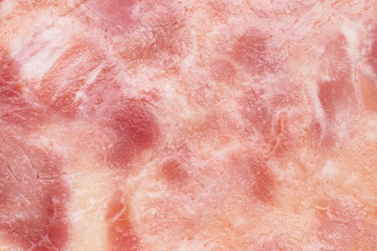 Photo 背景テクスチャ構成としてのハム肉のクローズアップフラグメント。