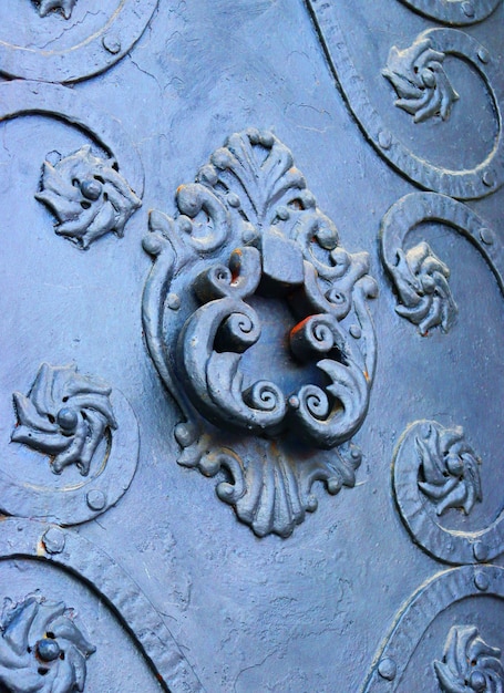 Close up fragment of medieval metal doors with decorative elements