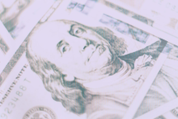 Close up Franklins face on a one hundred dollar American US Dollars Cash Money background Macro