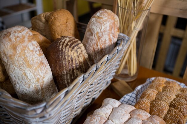 Close-up of fresh bread in a wicker basket on counter