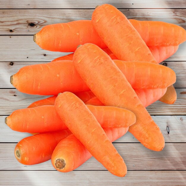 Close up of fresh carrot on wood background