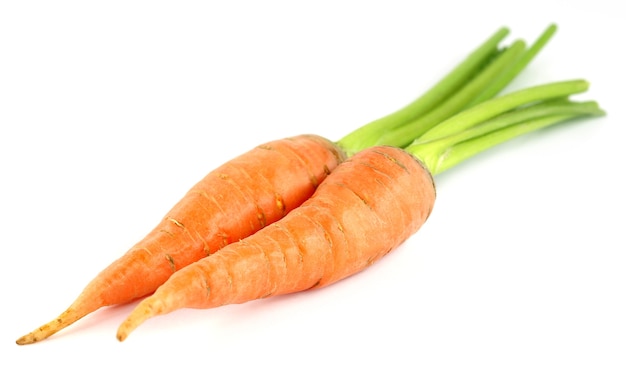 Close up of fresh carrots over white background