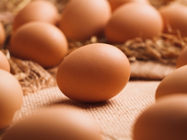 Close up fresh chicken brown eggs on natural burlap