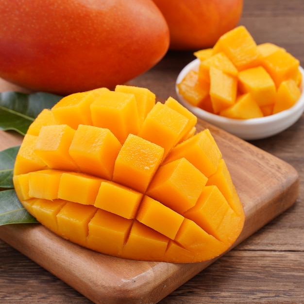 Close up of fresh chopped mango with green leaves 