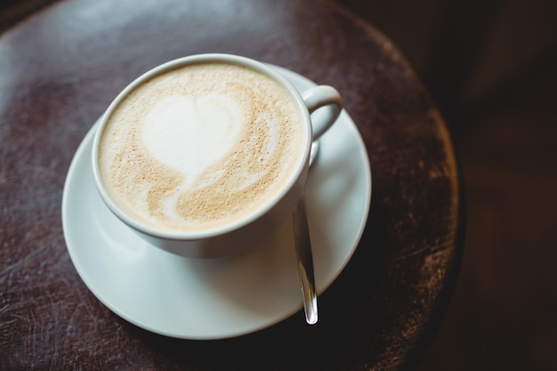 Close-up of fresh coffee served on table at cafe