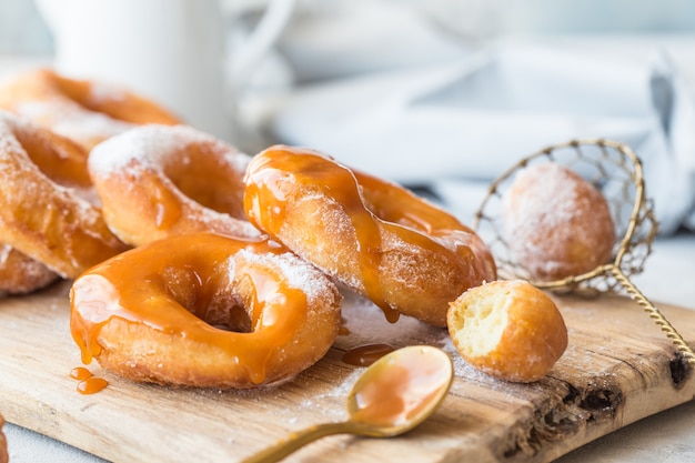 A close up of fresh glazed doughnuts in a studio setting.