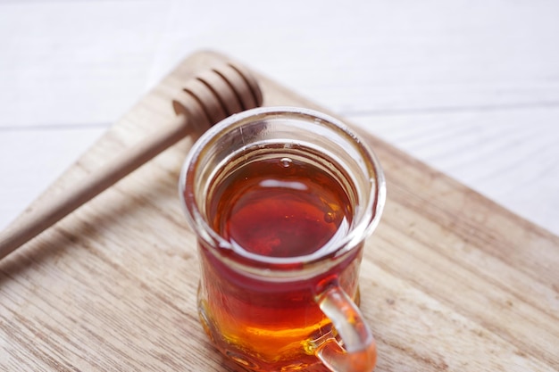 Close up of fresh honey with spoon on table