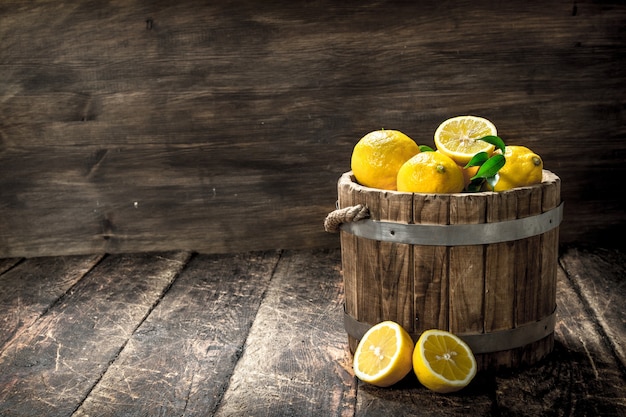 Close up on fresh lemons in a wooden bucket
