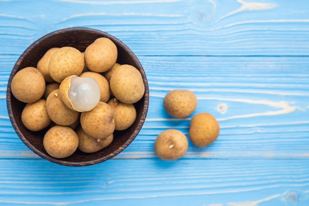 Close up fresh longan tropical fruit on blue wooden plank background