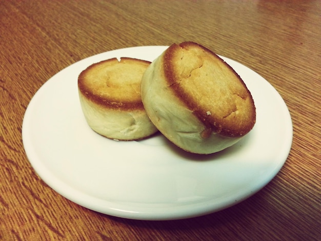Close-up of fresh muffins served in plate on table
