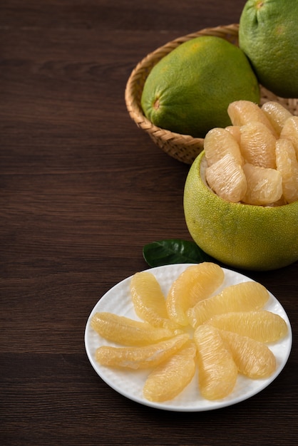 Close up of fresh peeled pomelo on wooden table background for Mid-Autumn Festival fruit.