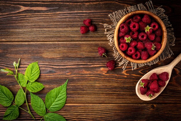 Close up on fresh raspberry in wooden bowl