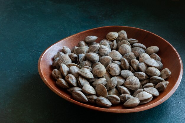 Close up of Fresh raw Surf clam in the wooden bowl